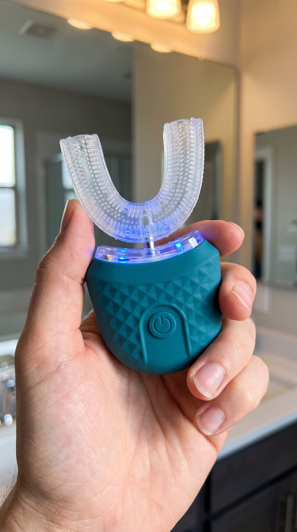 Hand holding the compact SwiftSmile toothbrush in a bathroom