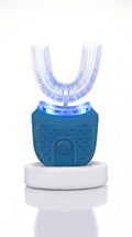 SwiftSmile U-shaped automatic toothbrush with blue light on its white charging base